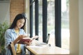 Young asian woman sitting and reading book. Royalty Free Stock Photo