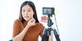 Young Asian woman recording a video for a woman beauty blogger. Makeup Tutorial. Royalty Free Stock Photo