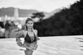 Young asian woman in red swimsuit posing at swimming pool Royalty Free Stock Photo