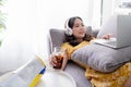 Young Asian woman are relaxing using social media follow news on tablet. She works at home Royalty Free Stock Photo