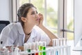 young asian woman research scientist preparing test tube and analyzing microscope With Computer in Laboratory . angry,