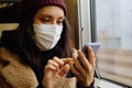 Young Asian Woman In Respirator Mask Using Smartphone In A Train. Ecological Pollution Air Infection Coronavirus Concept Royalty Free Stock Photo