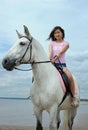 Young asian woman riding white horse Royalty Free Stock Photo