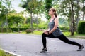 Young asian woman runner doing stretch exercise stretching legs Royalty Free Stock Photo