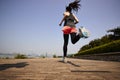 Young asian woman running outdoors