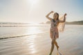 Young Asian woman running and playing on beach, Beautiful female relax on beach near sea when sunset in evening. Lifestyle woman Royalty Free Stock Photo