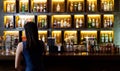 Young Asian woman with a sad face drinking cocktails in front of a vintage bar, Relaxing activities after work or hangouts