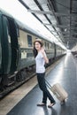 Young Asian woman say goodbye to boyfriend at train station before journey