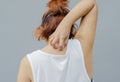 young asian woman scratching itch with hand on upper back area, health care concept, dermatosis Royalty Free Stock Photo