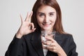 Young Asian woman show OK with a glass of drinking water. Royalty Free Stock Photo