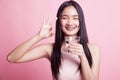 Young Asian woman show OK with a glass of drinking water. Royalty Free Stock Photo