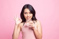 Young Asian woman show OK with a glass of drinking water Royalty Free Stock Photo