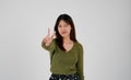 Young asian woman showing two fingers, positive or peace gesture, on white background Royalty Free Stock Photo