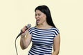 Young asian woman is singing songs with microphone. Royalty Free Stock Photo