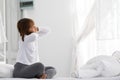 Young Asian woman sitting on bed has neck pain after wake up Royalty Free Stock Photo