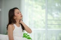 Ã Â¸Â±young Asian woman sitting on bed has neck pain after wake up Royalty Free Stock Photo