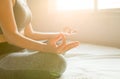 Young asian woman sitting on bed practicing doing yoga meditating,workout exercise after waking up in morning,Healthy and lifestyl Royalty Free Stock Photo