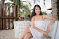 Young Asian woman sitting on bench relax on beach, Beautiful female happy relax near sea. Lifestyle women travel on beach concept Royalty Free Stock Photo