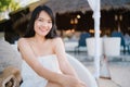 Young Asian woman sitting on bench relax on beach, Beautiful female happy relax near sea. Lifestyle women travel on beach concept Royalty Free Stock Photo