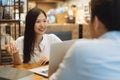 Young Asian woman sitting in cafe talking and having a meeting. Royalty Free Stock Photo