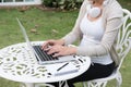 Young asian woman sitting on chair with headphone using laptop. Royalty Free Stock Photo