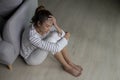 Young Asian woman sitting on floor at home feeling sad tired and worried suffering depression in mental health Royalty Free Stock Photo