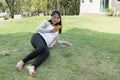 Young asian woman sitting in fresh spring grass listening to mus Royalty Free Stock Photo