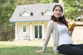 Young asian woman sitting in fresh spring grass listening to mus Royalty Free Stock Photo