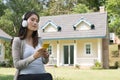 Young asian woman sitting in fresh spring grass listening to mus Royalty Free Stock Photo