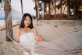 Young Asian woman sitting on hammock relax on beach, Beautiful female happy relax near sea. Lifestyle women travel on beach Royalty Free Stock Photo