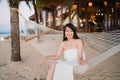 Young Asian woman sitting on hammock relax on beach, Beautiful female happy relax near sea. Lifestyle women travel on beach Royalty Free Stock Photo