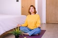 Young asian woman sitting practicing doing yoga meditation in bedroom,Workout exercise after waking up in morning,Healthy and life Royalty Free Stock Photo
