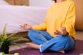 Young asian woman sitting practicing doing yoga meditation in bedroom,Workout exercise after waking up in morning,Healthy and life Royalty Free Stock Photo