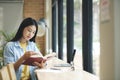 Young asian woman sitting and reading book. Royalty Free Stock Photo