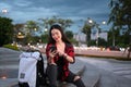 Young woman sitting on stairs in urban city at night and using smart phone. Royalty Free Stock Photo