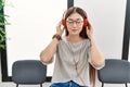 Young asian woman sitting wearing headphones at waiting room Royalty Free Stock Photo