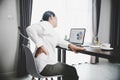 Young asian woman is sitting at work and has tension pain in her neck. Concept office syndrome backache pain from occupational Royalty Free Stock Photo