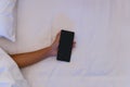 Young Asian woman sleeping while hand holding smartphone on bed at night. mobile phone  internet addiction concept Royalty Free Stock Photo