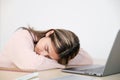 Young asian woman sleeping at her working desk Royalty Free Stock Photo