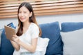 Young asian woman smiling holding credit card shopping online with tablet computer buying and payment. Royalty Free Stock Photo