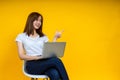 Young Asian woman teen smiling sitting on chair wearing t-shirt using laptop computer Royalty Free Stock Photo