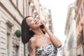 Young asian woman smiling using mobile phone urban scene Royalty Free Stock Photo