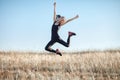 Young Asian woman in sports clothes happy jumping outdoors Royalty Free Stock Photo