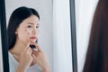 Young Asian woman squeeze acne problem face