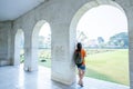 Young asian woman standing at the arched entrance of Kanchanaburi War Cemetery Don Rak Royalty Free Stock Photo