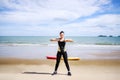 Young Asian woman is stretching or warm-up her body before exercise by running on the beach in the morning and get fresh air. Royalty Free Stock Photo