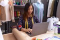 Young asian woman tailor using laptop at atelier Royalty Free Stock Photo