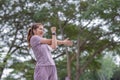Young Asian woman takes care of her health by exercising. Stretch your legs in the park