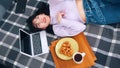 Young asian woman taking photo of her and her breakfast. Young influencer posting on social media Royalty Free Stock Photo