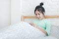 Young Asian woman taking selfie photo in bedroom